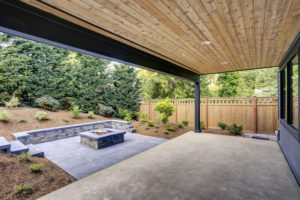 New modern home features a backyard with patio