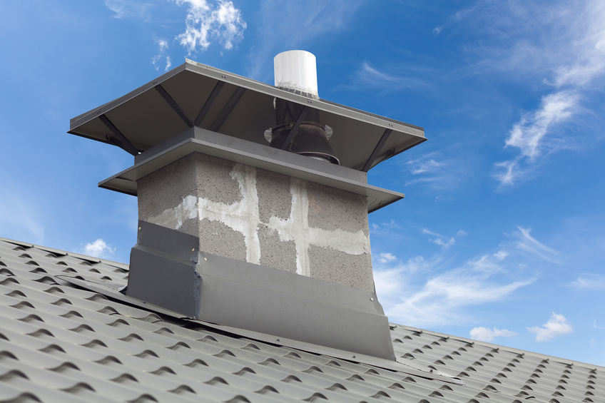 New gray metal tile roof with chimney