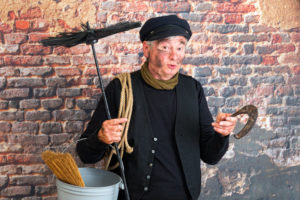 Chimney sweep wishing good fortune with a rusty horseshoe