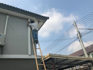 worker fixing crack ceiling and roof of the house
