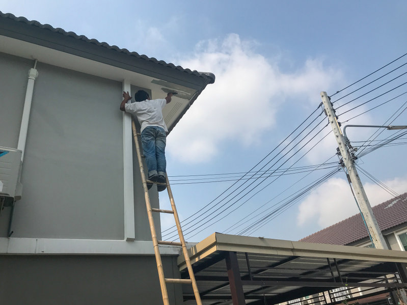 worker fixing crack ceiling and roof of the house