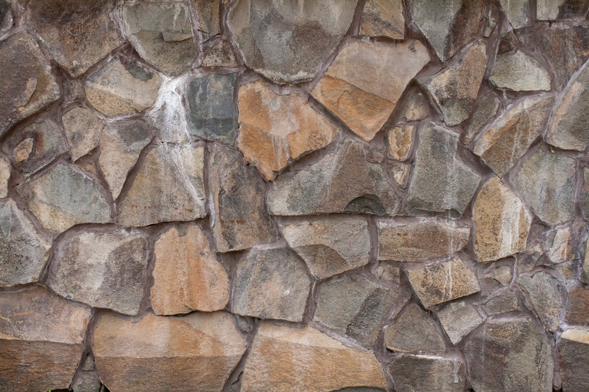 The texture of rough stone. Masonry from large boulders